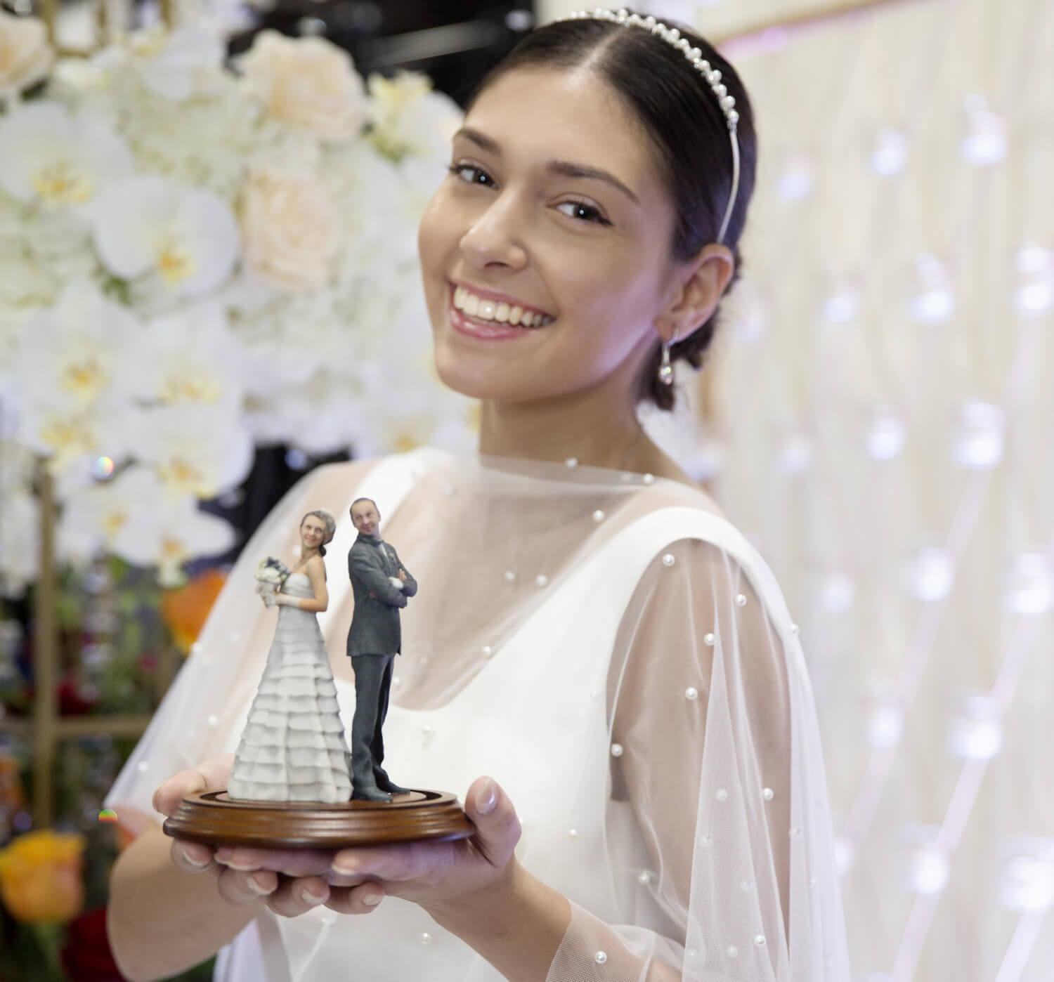 Cake topper in hands of a bride